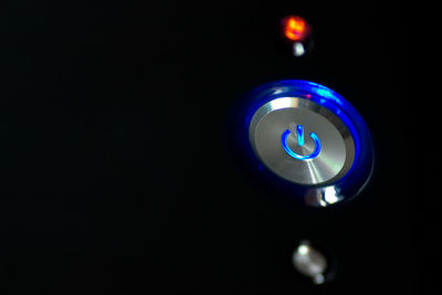 Close-up of illuminated lamp against black background