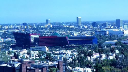 High angle view of buildings against clear blue sky