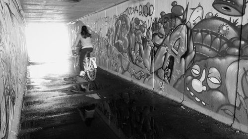 Rear view of man walking by water