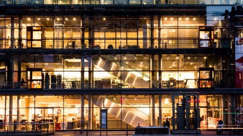 Exterior of illuminated shopping mall at night