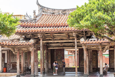 People outside temple against building