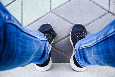 Low section of men standing on footpath