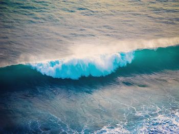 High angle view of waves rushing towards shore