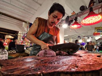 Man working at illuminated market