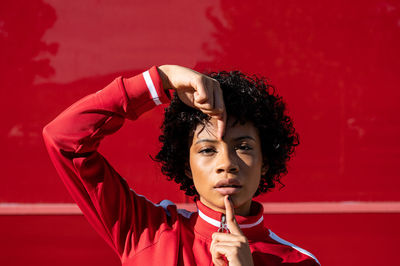 African american woman with short hair and urban dress with red background