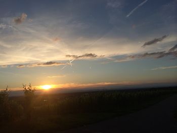 Scenic view of field against sky at sunset