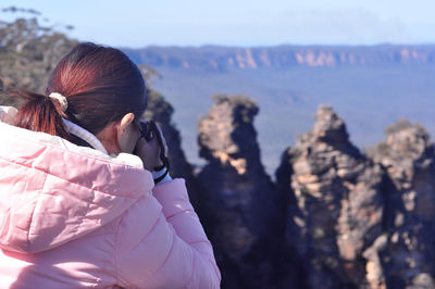 Woman photographing landscape