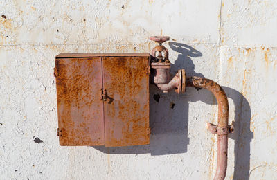 Close-up of rusty pipe on against wall