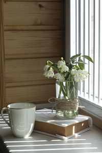 Flower vase on table at home