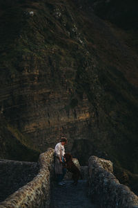 Woman on rock by mountain