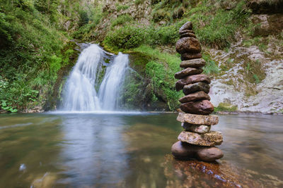 Stack of stones by waterfall