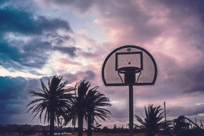 Basketball hoop against sky during sunset