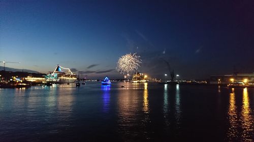 Illuminated ferris wheel at night