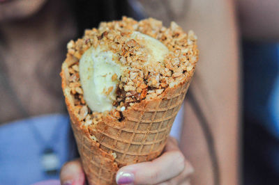 Midsection of woman holding ice cream cone