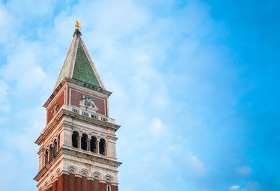 Low angle view of san marco campanile against cloudy sky