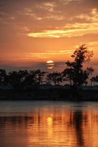 Scenic view of lake against romantic sky at sunset