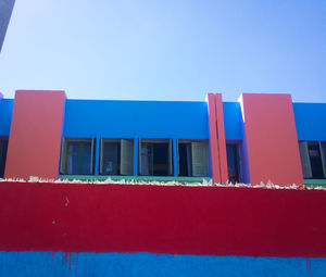 Low angle view of building against clear blue sky