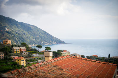 High angle view of townscape by sea against sky