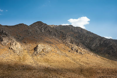 The shadow of clouds on a rocky mountain with autumnal foliage, rocky mountain khuzestan province, 