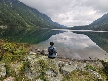 Rear view of man standing on rock