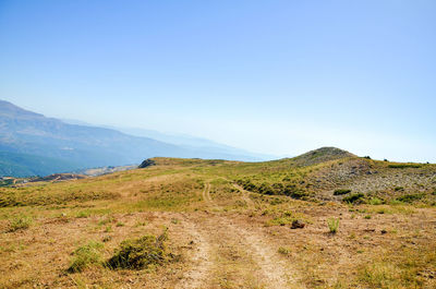 Scenic view of mountains against clear blue sky