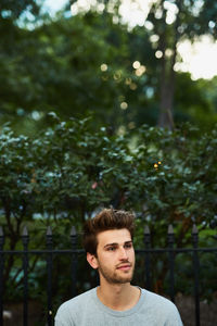 Young man against trees