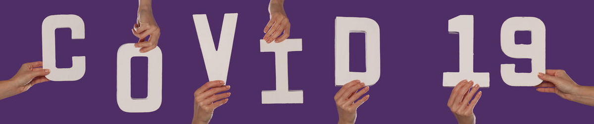Low section of woman holding text against black background