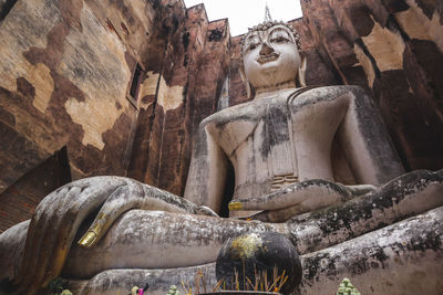 Low angle view of statue against temple