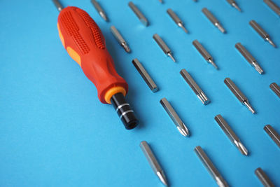 High angle view of piano keys on blue table