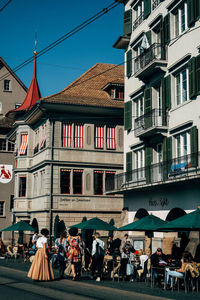 People in front of buildings in city