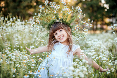 Portrait of smiling girl standing on field