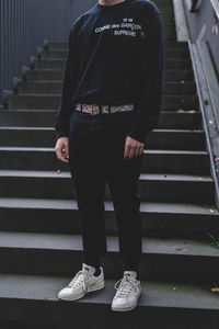 Low section of man standing on staircase