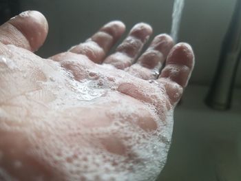 Close-up of hand holding water