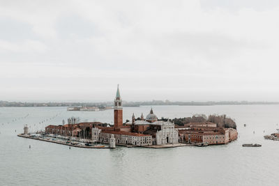 High angle view of buildings in town amidst sea