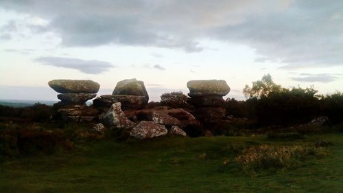 Hay bales on field against sky