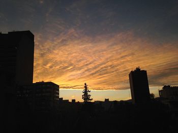 Low angle view of silhouette building against sky during sunset