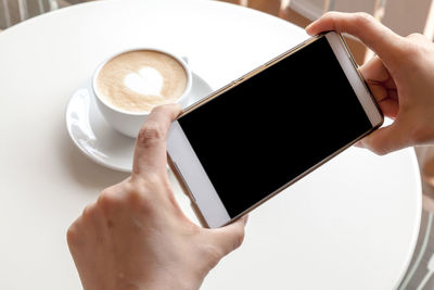 Close-up of woman holding coffee cup
