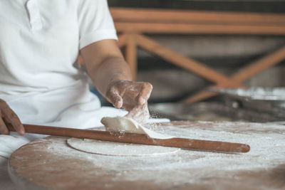 Midsection of man preparing food