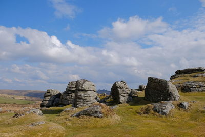 Rock formations on landscape against sky