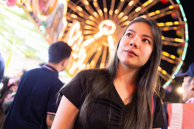 Close-up of young woman looking away outdoors