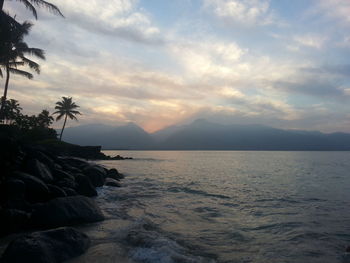 Scenic view of sea against cloudy sky