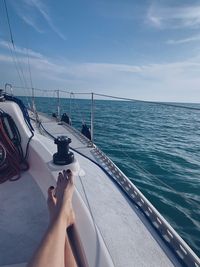 Man sailing on sea against sky