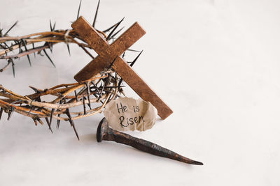 He is risen. jesus crown thorns and nails and cross on a white background. easter day