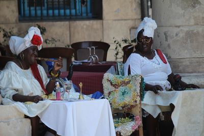 Group of people sitting at market stall