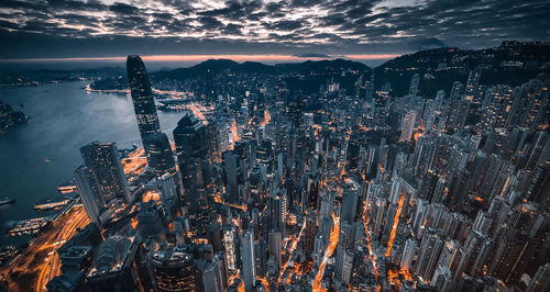 High angle view of illuminated buildings in city at sunset