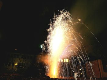 Low angle view of firework display against sky at night