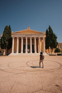 Rear view of man standing against clear sky