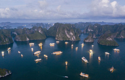 Aerial view of sea against mountain and sky