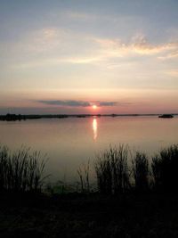 Scenic view of calm lake at sunset