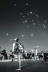 People in amusement park at night